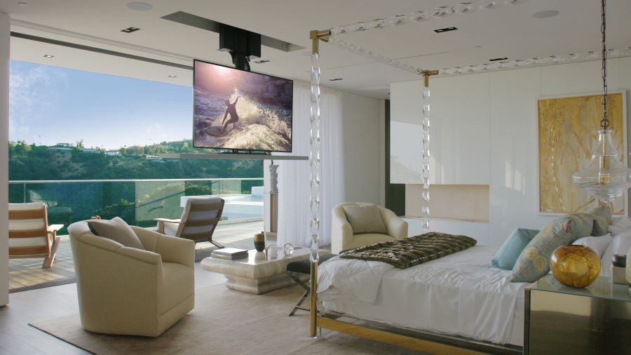 Bedroom with a TV dropping down from the ceiling.